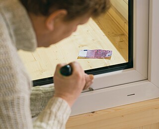 Mann beim Prüfen der Fenstersicherung der Hanse Haus Fenster